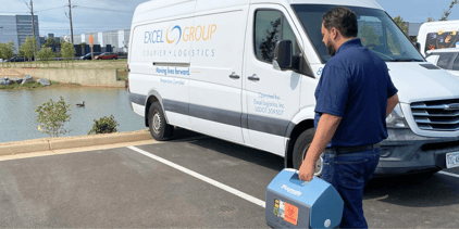 Driver walking to van with medical specimen