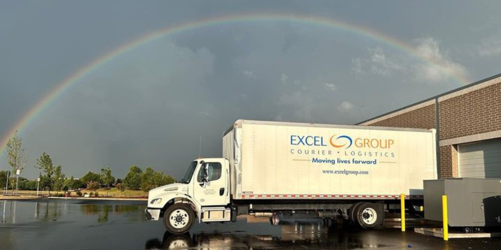 Straight truck with rainbow in sky